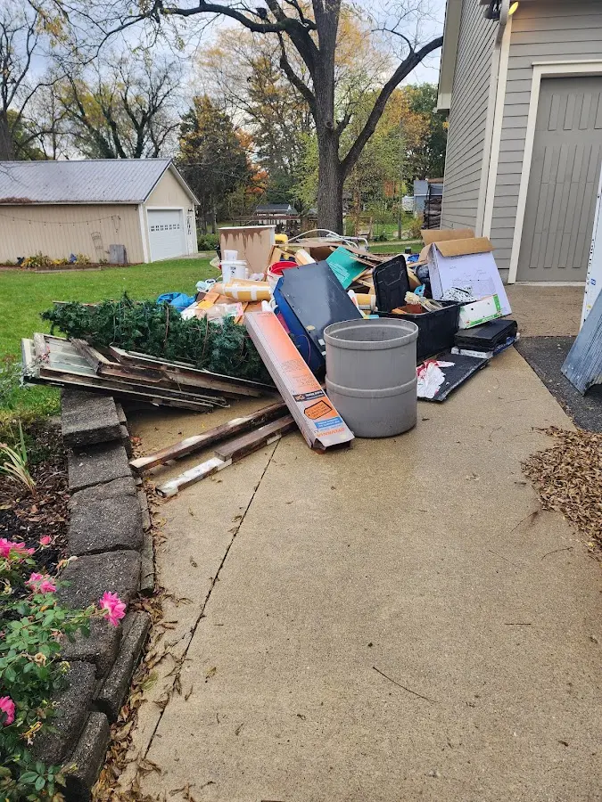 Dumpster being loaded with debris for Estate Cleanout Dumpster Rental in Baldwin